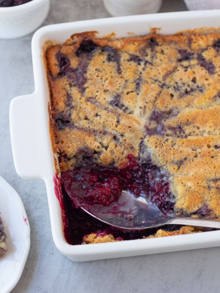 finished vegan blackberry cobbler with spoonful taken out